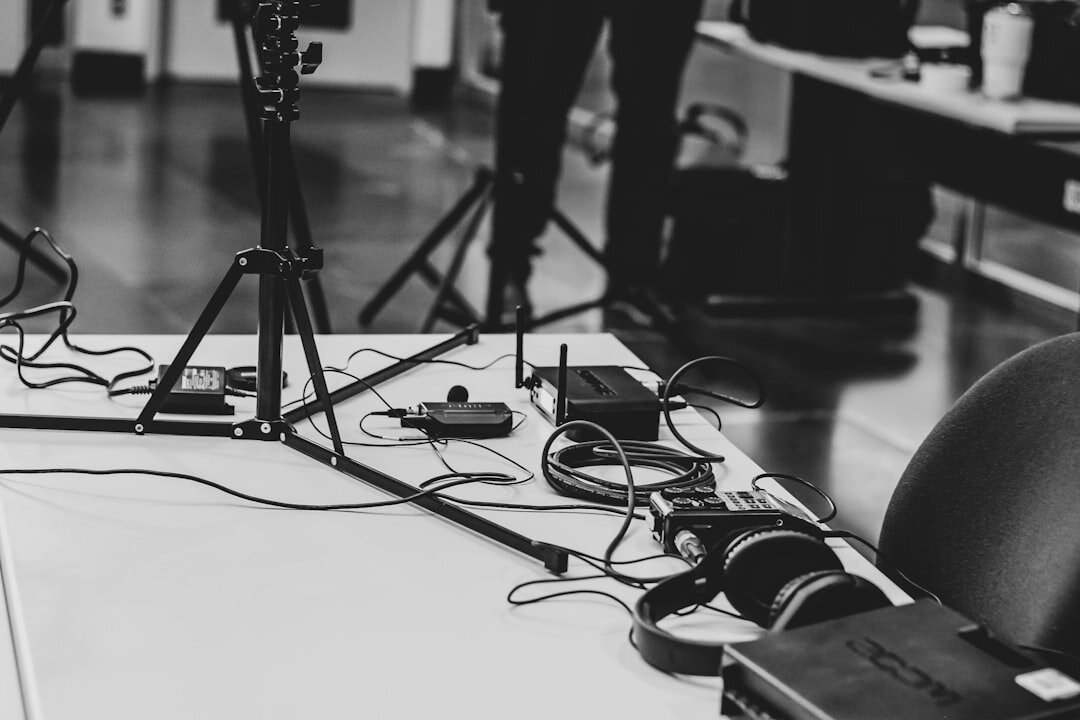 Camera planning session with storyboard diagrams and broadcast equipment on a table