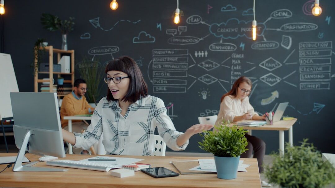 Modern media production office with digital workflow tools and multiple workstations