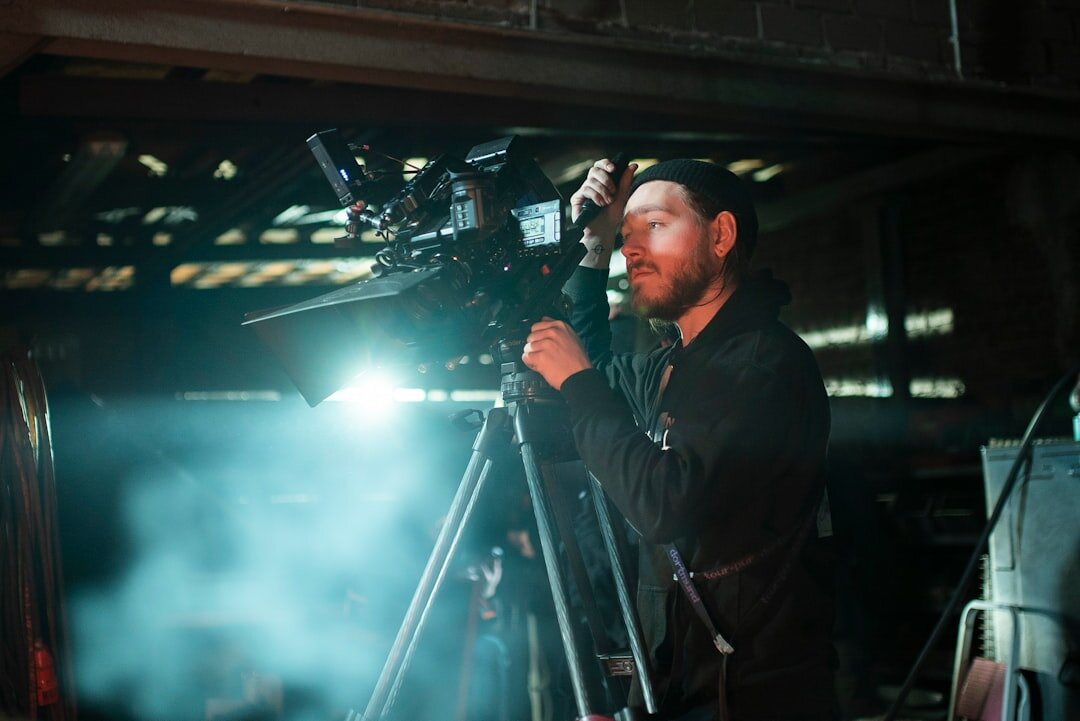 Cinematographer capturing visual storytelling with a cinema camera on a film set