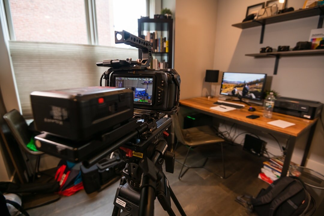 Virtual hybrid broadcast setup with professional camera and laptop for remote streaming