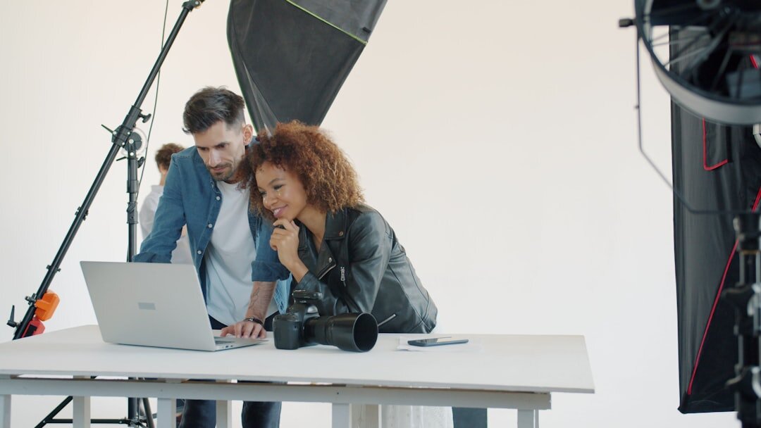 Two business professionals in a media studio discussing a partnership agreement