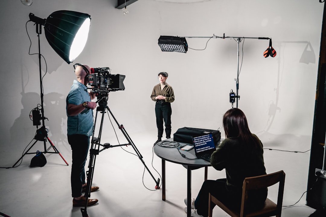Female journalist working in a modern TV studio with broadcast camera